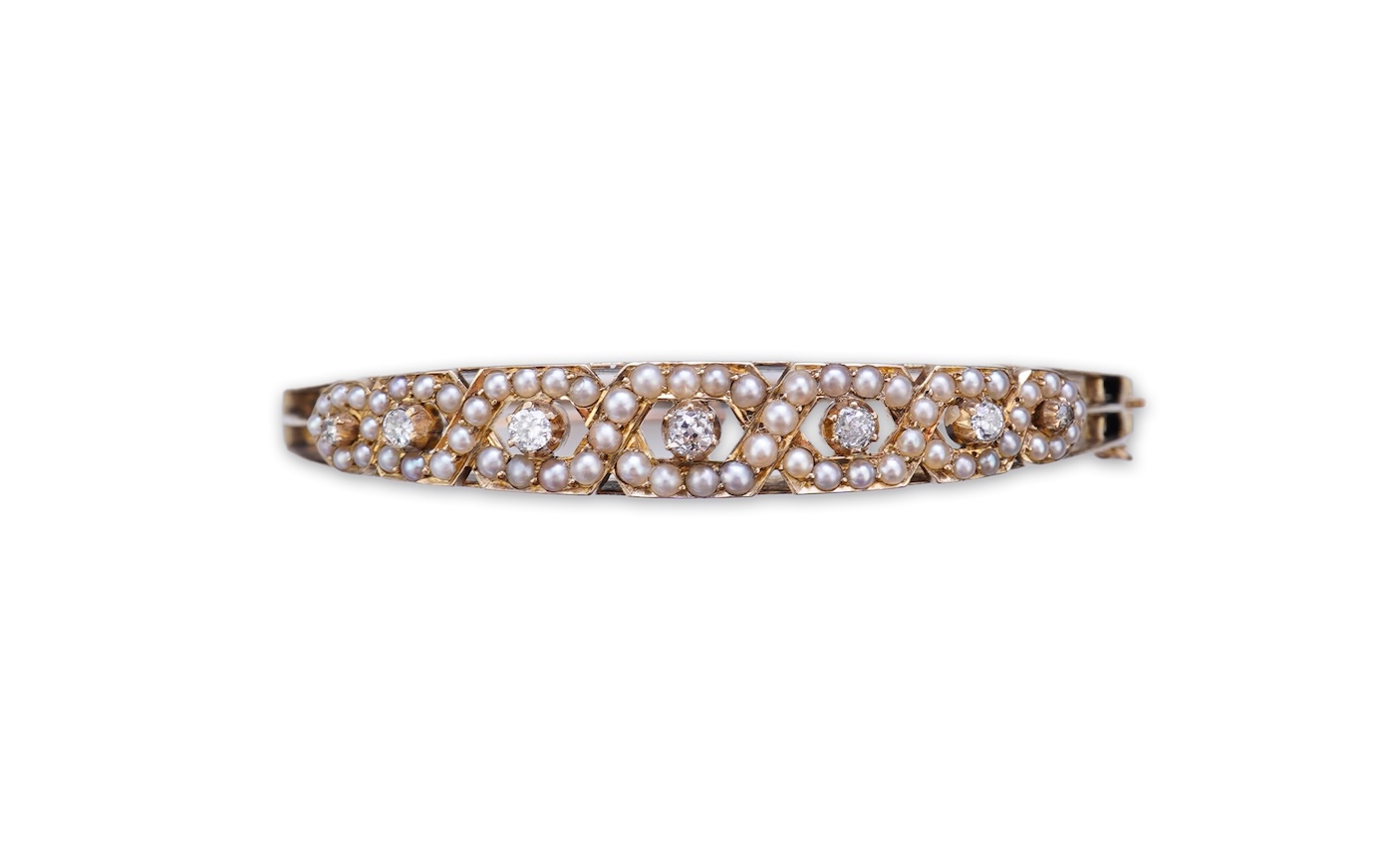 An Edwardian seed pearl and diamond bangle, early 20th century